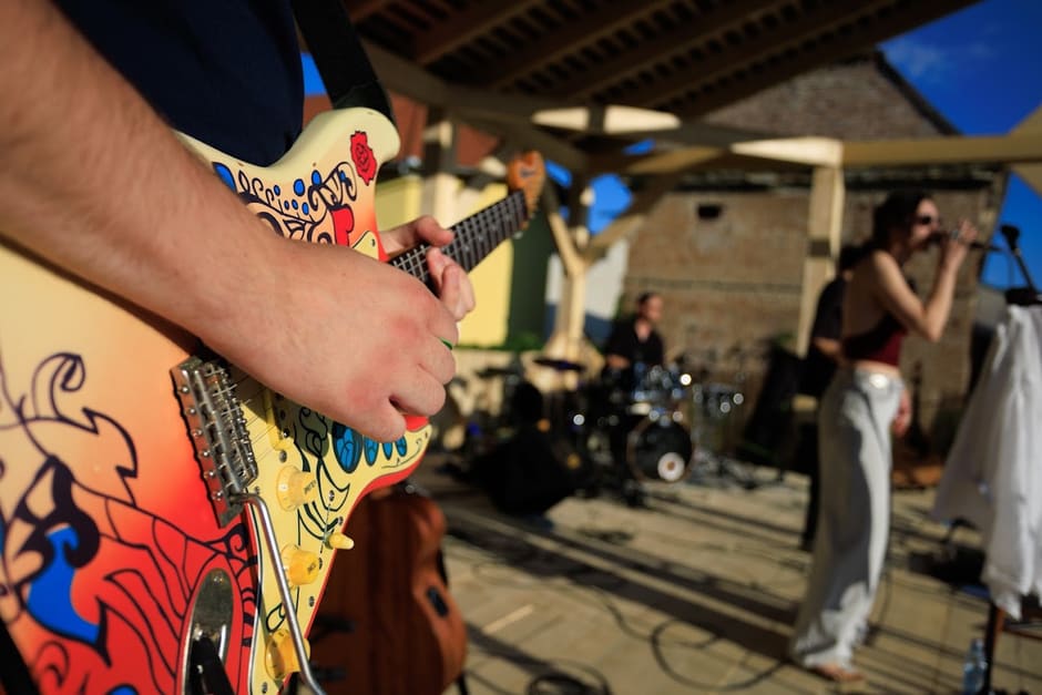 A MoonGroove guitarist playing on stage under warm light
