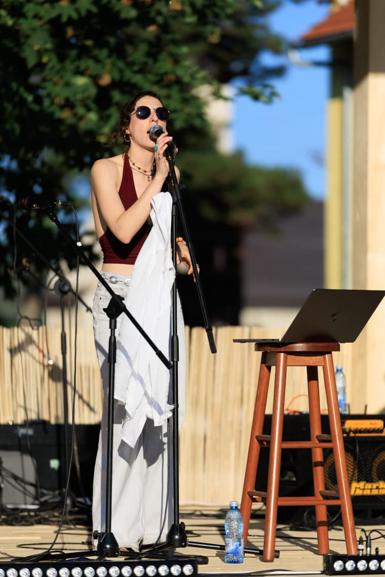 The singer at the microphone mid-phrase