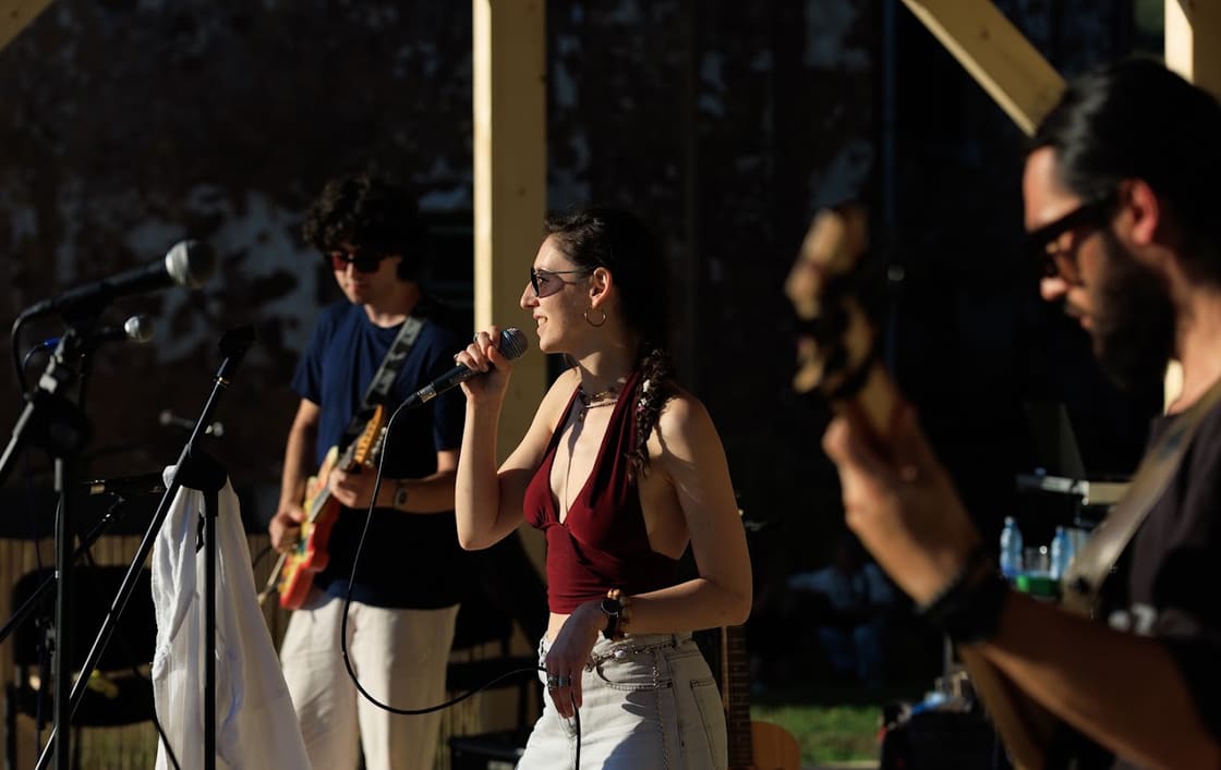 Moongroove performing on a wide club stage under warm light
